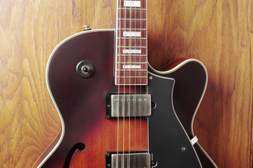 Obraz na płótnie Canvas Jazz guitar on a wooden textured background. Close-up