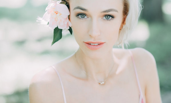 portrait of young woman with flower