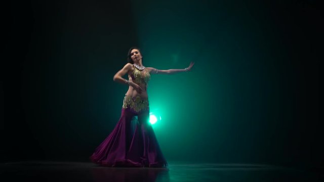 Woman sexually moves her semi nude body. Smoke background