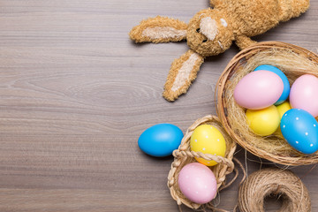 Fototapeta na wymiar Easter eggs in the basket on wooden background