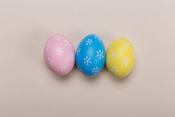 Colorfull easter eggs in nest on pastel color background with space. Concept