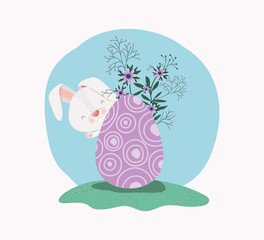 cute rabbit with egg painted and flowers in the garden