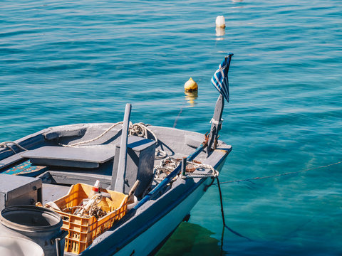 Detail view of a traditional greek fishing boat with Greek Flag in Limenas Port, Thasos Island