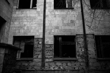 Those people in a dark black window of an abandoned building