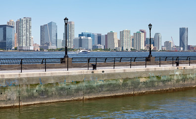 Jersey City skyline seen from Manhattan a sunny summer morning, USA.