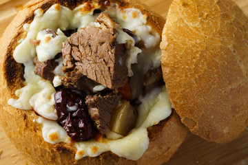 korean beef stew with cheese in bread bowl close up