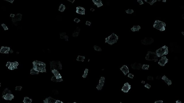 Particles of ice falling down on a black background