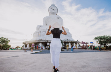 Beautiful thai girl visiting the big buddha in Phuket