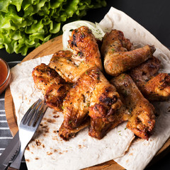 Grilled chicken wings. BBQ chicken wings with sauce. Closeup