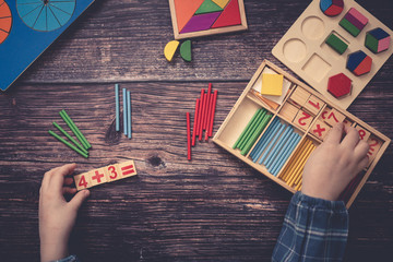 child decides an example. Wooden, top view