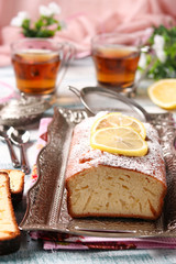 Lemon cupcake on a metal tray on a blue background