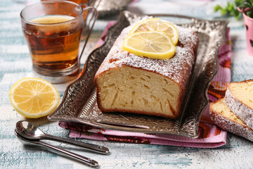 Lemon cupcake on a metal tray on a blue background