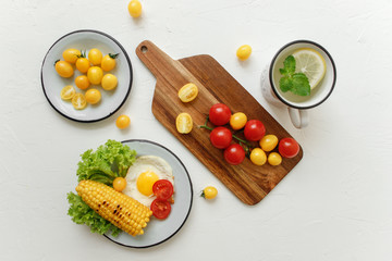 cherry tomatoes, eggs, corn and vegetablesv