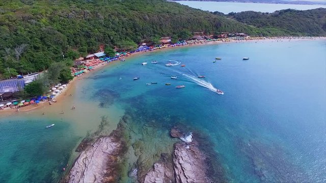 Brazil, Buzios - rocks and speedboats at Tartaruga Beach