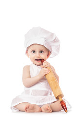 Baby wearing a chef hat with dough rolling pin, isolated on a white background. healthy food concept