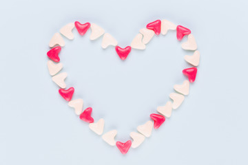 Valentines day background pastel hearts on blue wooden background.