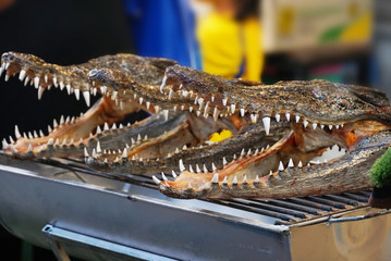 Roasted crocodile head on grill.
