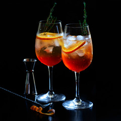 Aperol Stpritz  with bartender tools in the bar.  Classic Italian Alcoholic aperitif beverage, prepared with prosecco some bitter liqueur and soda water.