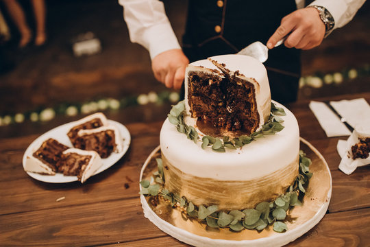 waiter is cutting the wedding cake