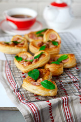 Puffs with sausages in heart shapes. Valentine's Day Breakfast