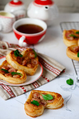 Puffs with sausages in heart shapes. Valentine's Day Breakfast