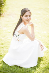 Fototapeta na wymiar Beautiful woman in white dress portrait outdoor