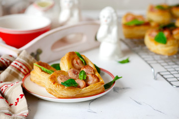 Puffs with sausages in heart shapes. Valentine's Day Breakfast