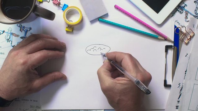 Artist drawing on a sheet a cup of cappuccino