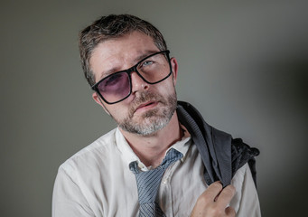 hilarious portrait of 40s weird and wasted businessman in suit and tie wearing ridiculous big...
