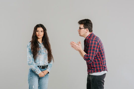 the husband asks for forgiveness from his wife, familiar problems, isolated on the gray background