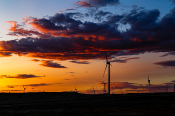 Aug 2017 – Xinjiang, China – Wind Turbines at sunset in Burqin County, North of Xinjiang. The deserts of Xinjiang, the westernmost province of China, are full of Wind Turbine Power Plants