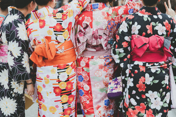 Young girl wearing Japanese kimono standing in front of Sensoji Temple in Tokyo, Japan. Kimono is a Japanese traditional garment. The word "kimono", which actually means a "thing to wear"