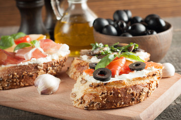 Italian tomato and cheese bruschetta. Tapas, antipasti with chopped vegetables, herbs and oil on grilled ciabatta and baguette bread.