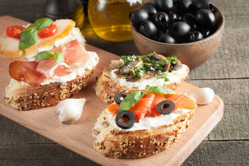 Italian tomato and cheese bruschetta. Tapas, antipasti with chopped vegetables, herbs and oil on grilled ciabatta and baguette bread.