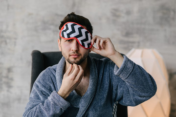 Happy man or bearded macho with beard smiling in open blue robe on sexy naked torso, belly, chest. Home and leisure clothing. Resting and relaxing - Image. Good morning.
