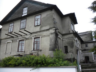 Closeup of old house with aged grey walls and windows