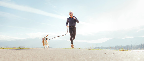 Running man with his dog . Active healthy lifestyle concept image.