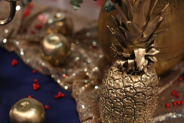 Close up view of golden pineapple. Minimal fruit concept. Pineapple silhouette in gold 