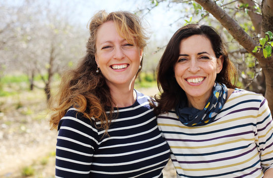 Portrait of two smiling real mature women outdoor