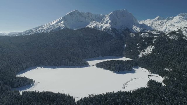 Aerial winter view of snow covered Black lake in Durmitor mountains national park