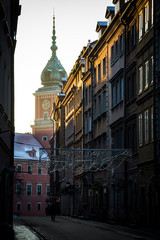 Spire of the Warsaw Royal Castle seen from sunlit street