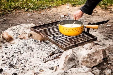 Swiss cheese fondue cooked in an outside firewood.  © Sofia