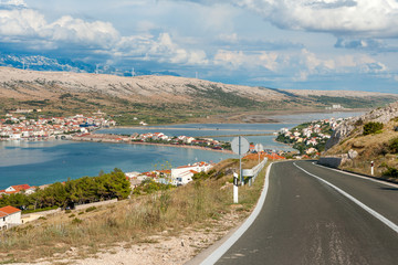 Driving through Pag island with the view of Pag town, Adriatic coast and Velebit mountains, Croatia