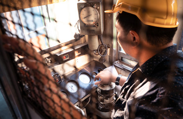Train driver checking engine of train and gesture the hand to already from the station