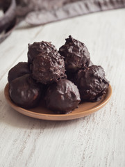Energy balls from carob on a wooden table.