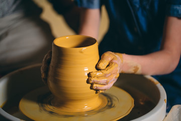Pottery workshop. A little girl makes a vase of clay. Clay modeling