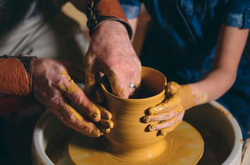 Pottery workshop. Grandpa teaches granddaughter pottery. Clay modeling