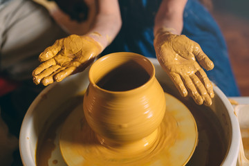 Pottery workshop. A little girl makes a vase of clay. Clay modeling