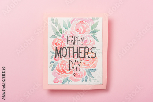 happy mothers day greeting card with flowers on pink background