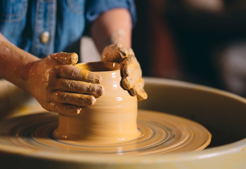 Pottery workshop. A little girl makes a vase of clay. Clay modeling